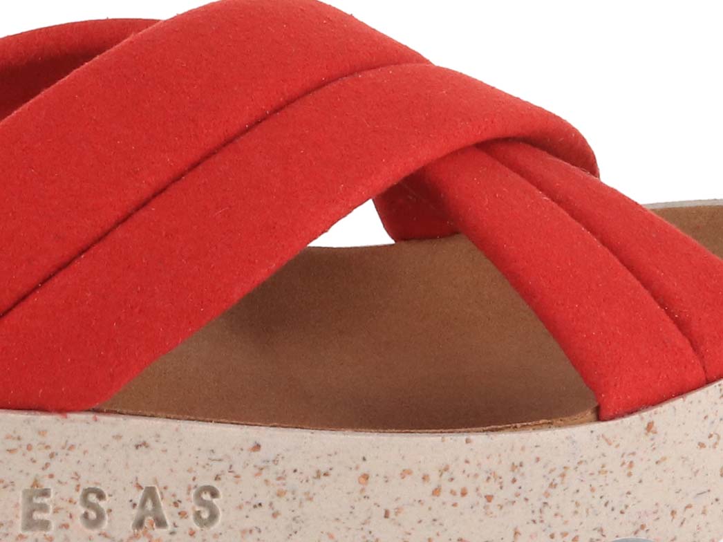 Close view of crossed ruby sandal straps and footbed