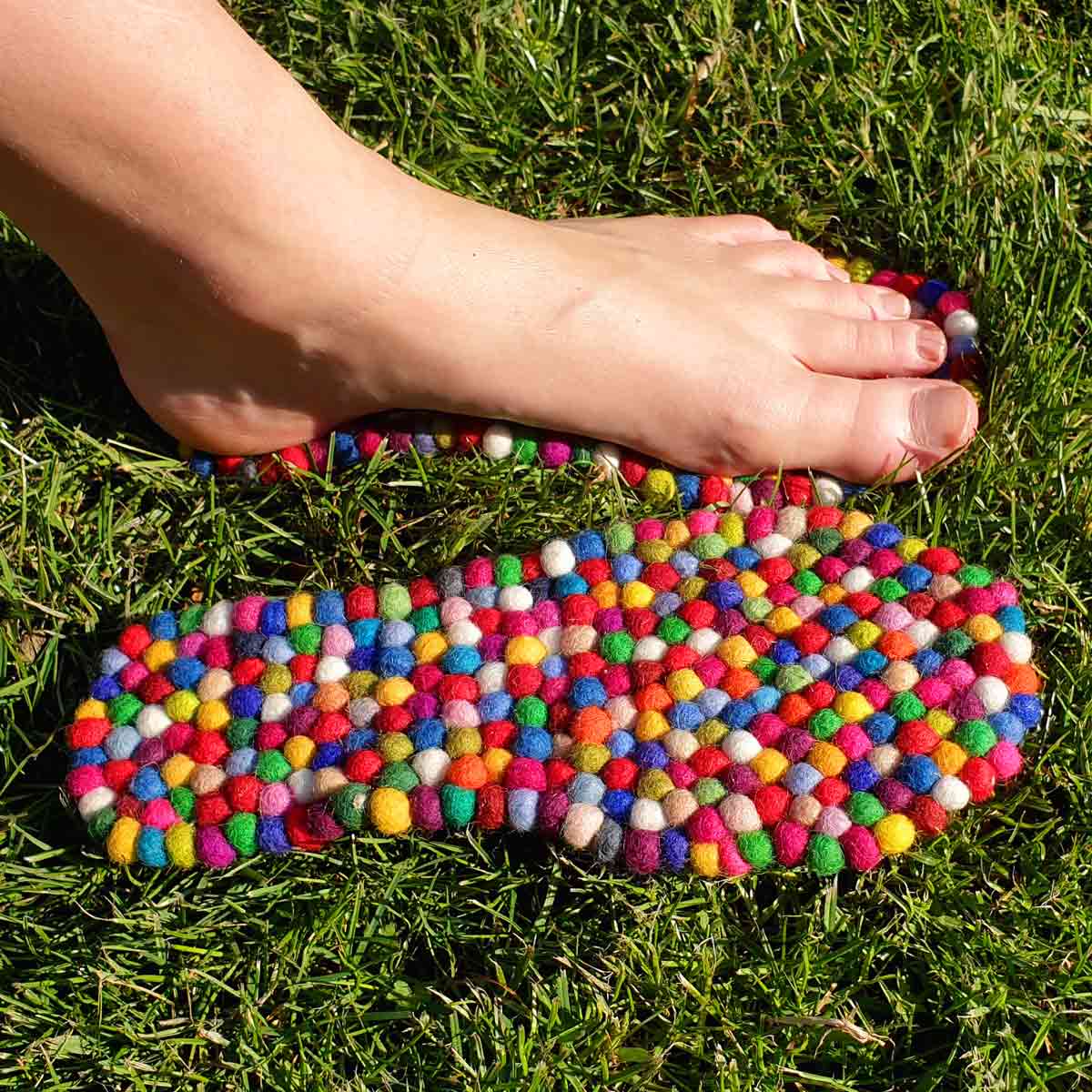 Bare foot pressing on colorful WoolFit FeelGood wool footbeds outdoors