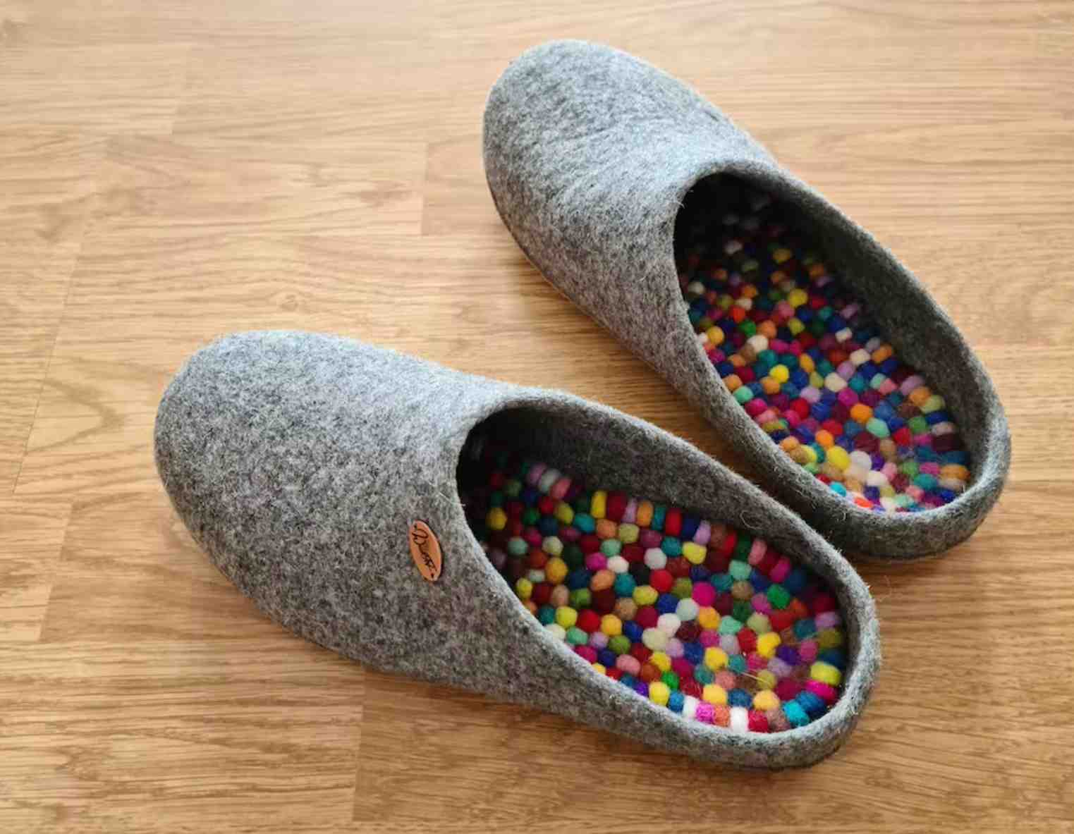 Colorful WoolFit FeelGood footbeds inside gray felt slippers