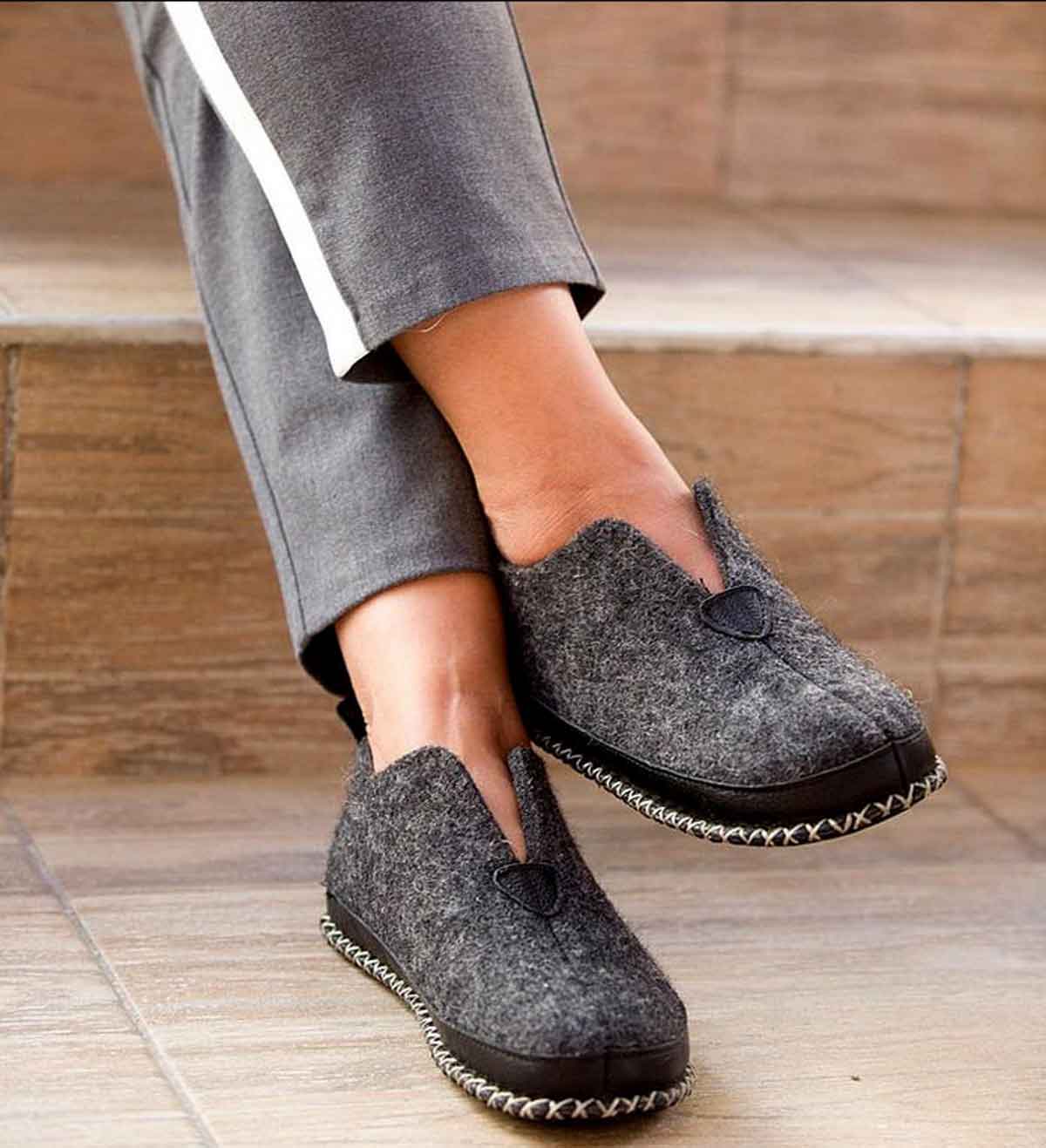Tuffeln Urig dark and light gray wool slippers worn indoors